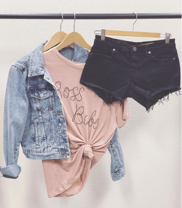 M.Marie jacket, graphic tee, and shorts hanging on a rack